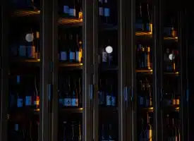 brown wooden glass cabinet with bottles
