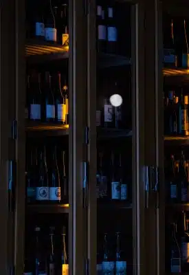brown wooden glass cabinet with bottles