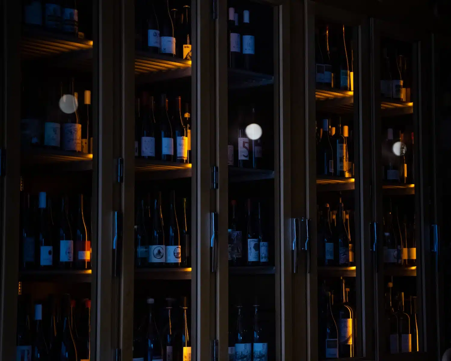brown wooden glass cabinet with bottles